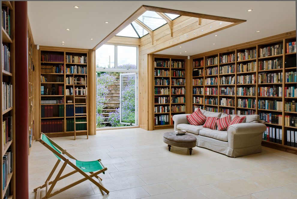 Photo of a country enclosed games room in London with a reading nook, white walls and beige floors.