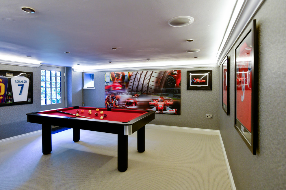 Example of a mid-sized minimalist carpeted, gray floor, tray ceiling and wallpaper game room design in Other with gray walls and a media wall