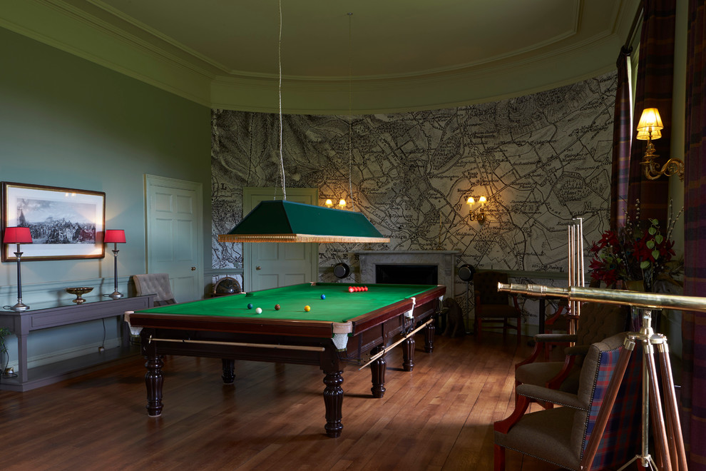Photo of a classic enclosed games room in Other with multi-coloured walls, medium hardwood flooring, a standard fireplace, no tv and a feature wall.
