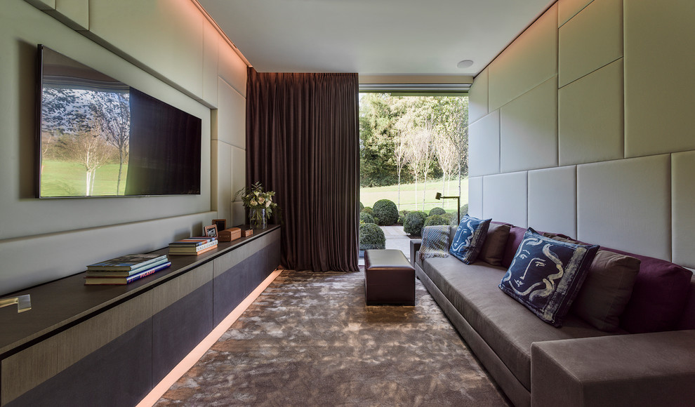 This is an example of a contemporary enclosed games room in London with beige walls and a wall mounted tv.