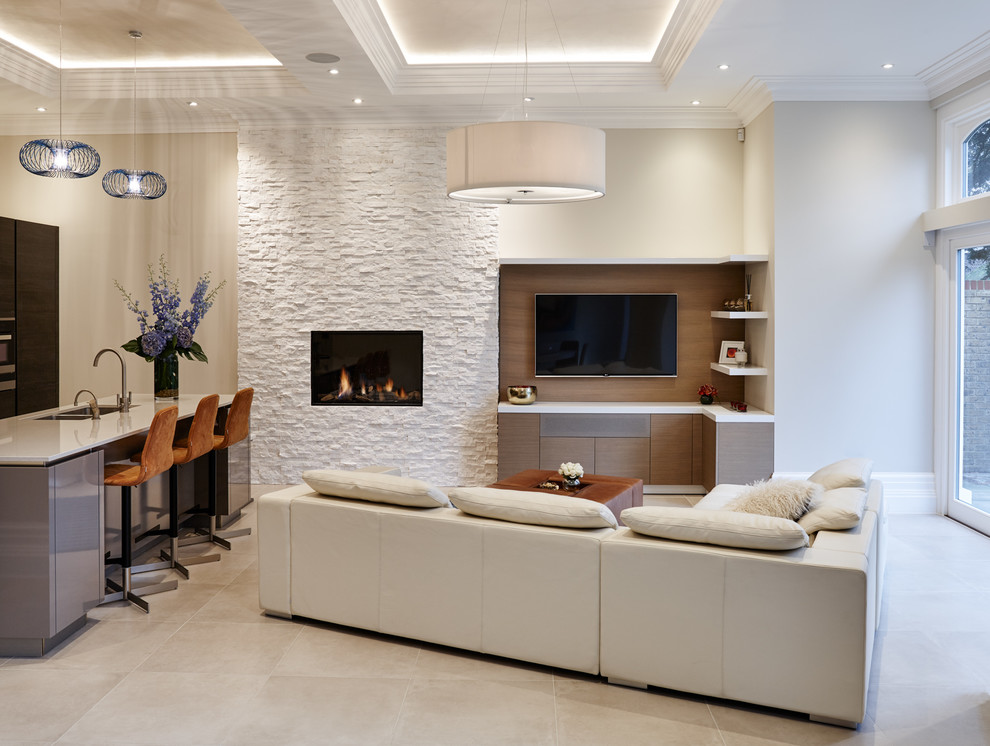 Design ideas for a contemporary open plan games room in Orange County with white walls, a standard fireplace, a stone fireplace surround and a wall mounted tv.