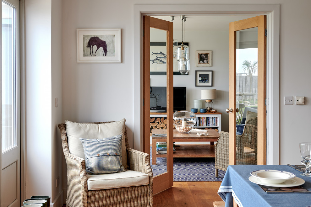Inspiration for a medium sized nautical open plan games room in Hampshire with a reading nook, white walls, medium hardwood flooring and brown floors.