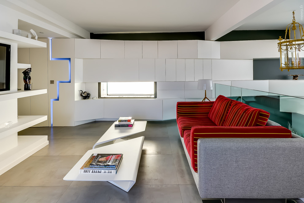 Свежая идея для дизайна: двухуровневая гостиная комната среднего размера в современном стиле с серыми стенами и телевизором на стене - отличное фото интерьера