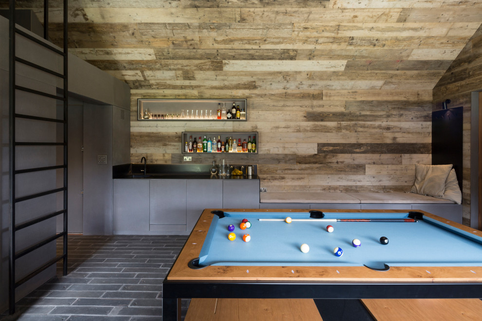 Design ideas for a contemporary games room in Hampshire with brown walls, grey floors, a vaulted ceiling and wood walls.