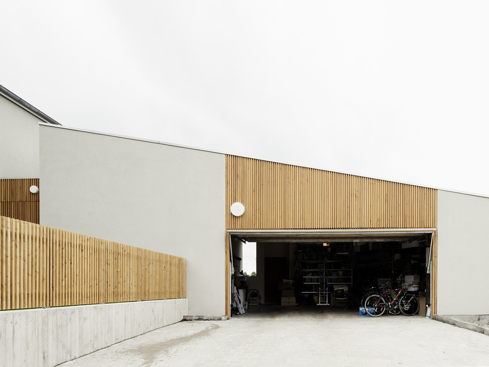 Inspiration för en stor funkis tillbyggd tvåbils garage och förråd