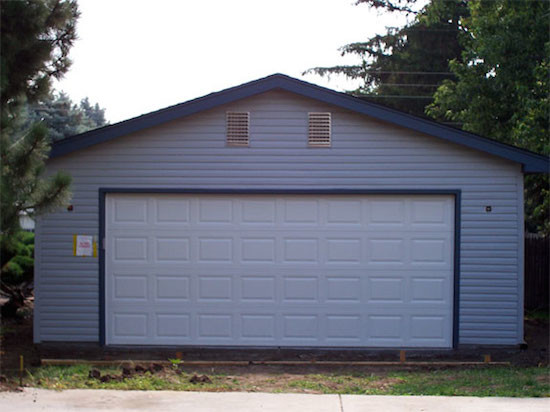 Example of a mid-sized detached two-car garage design in Denver
