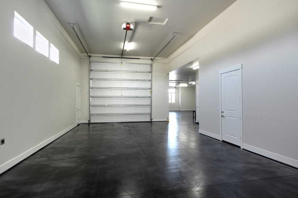 Huge transitional attached three-car garage photo in Boise