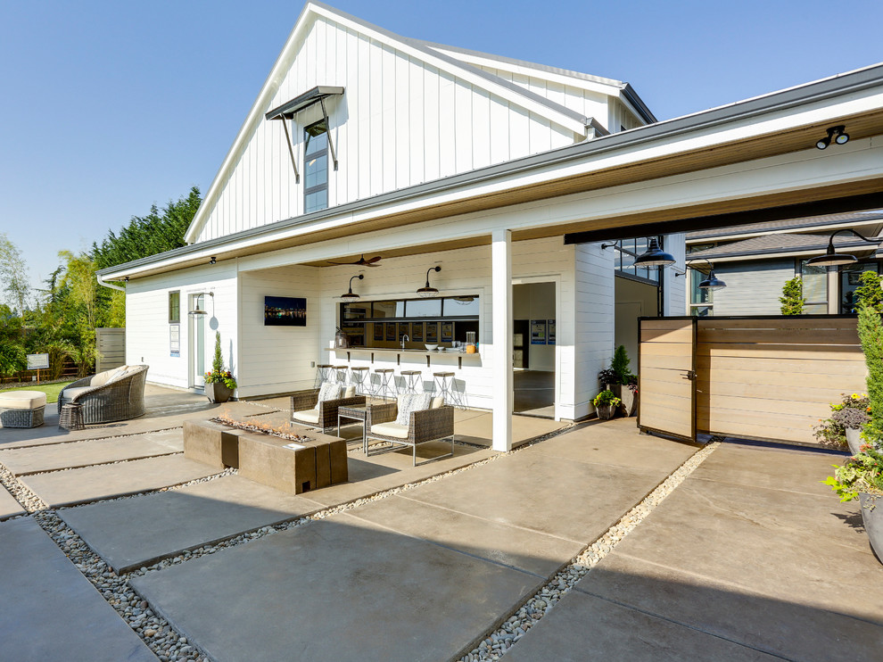 Example of a huge cottage detached four-car garage workshop design in Portland