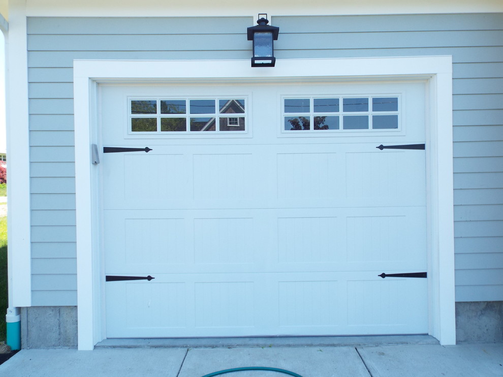 Example of a small trendy attached one-car garage design in Providence