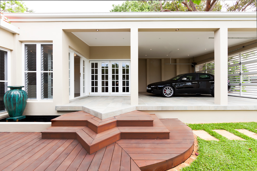 Пример оригинального дизайна: пристроенный гараж среднего размера в стиле модернизм с навесом для автомобилей для двух машин