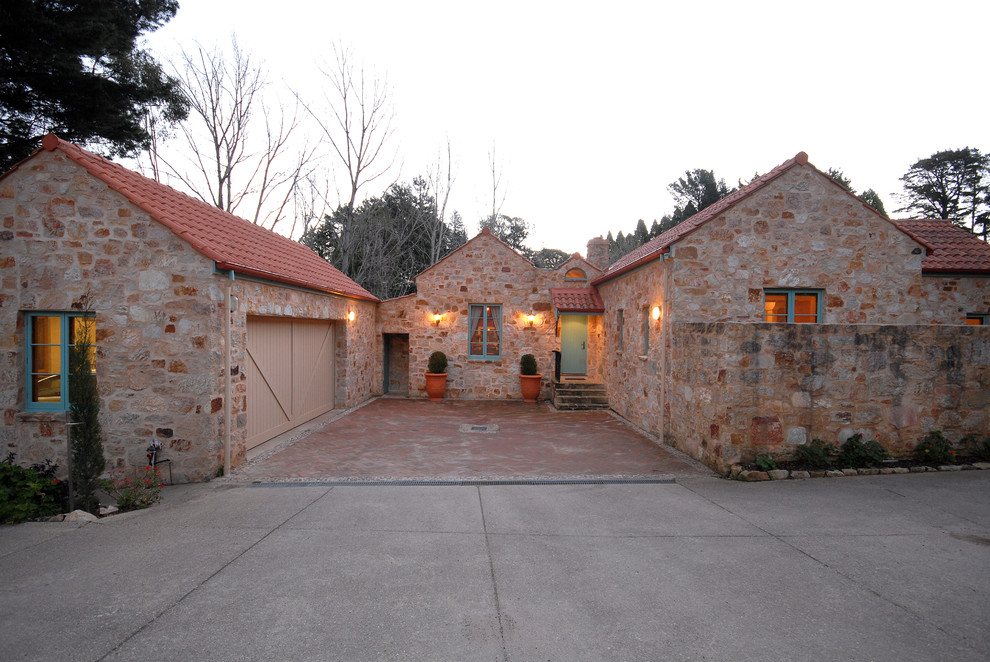 Photo of a large mediterranean attached double garage in Adelaide.