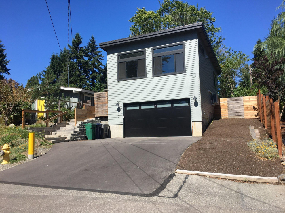 Example of a small transitional detached two-car garage workshop design in Seattle