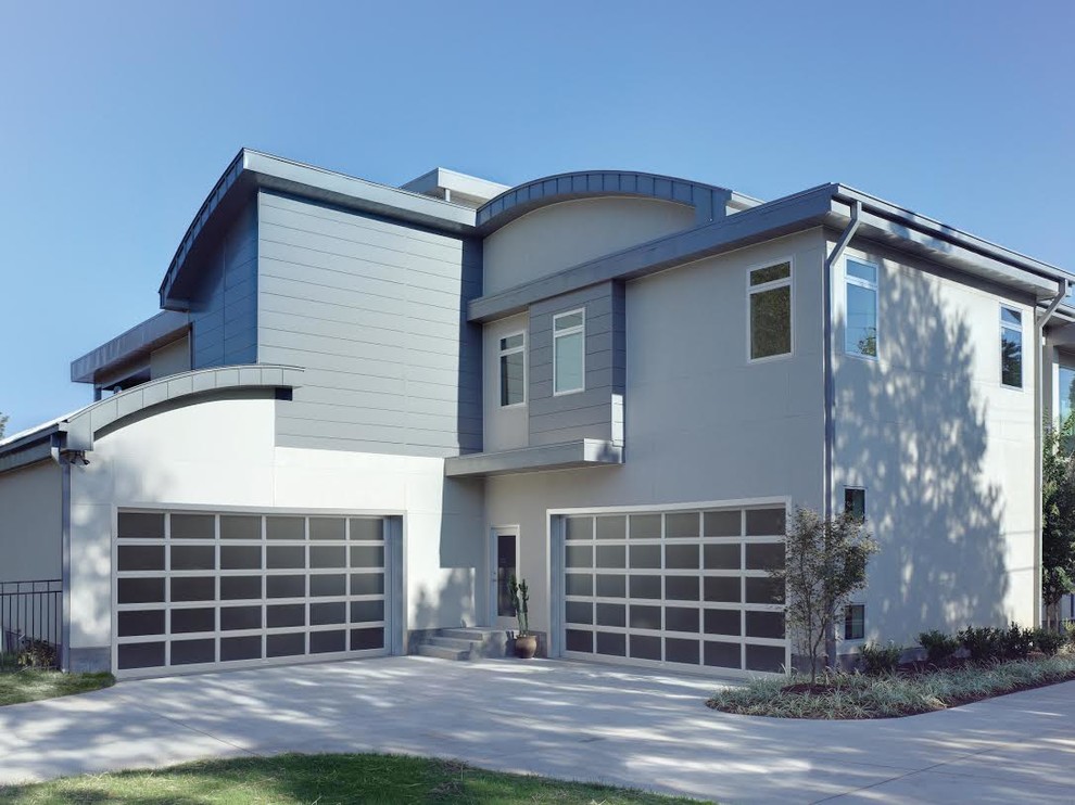 Idée de décoration pour un garage pour deux voitures attenant design de taille moyenne.