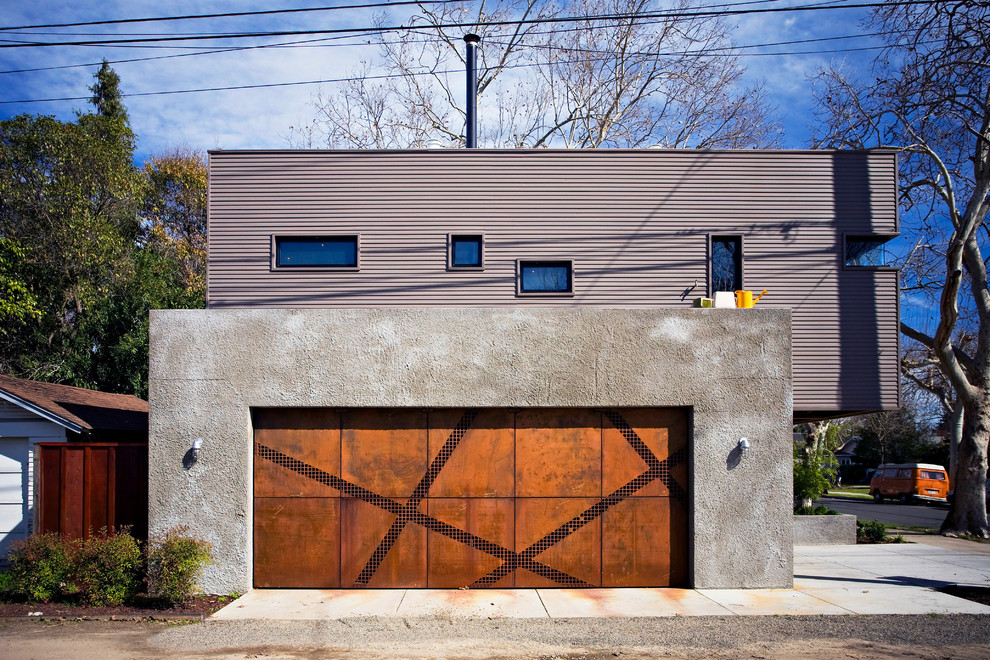 На фото: пристроенный гараж в стиле лофт для двух машин