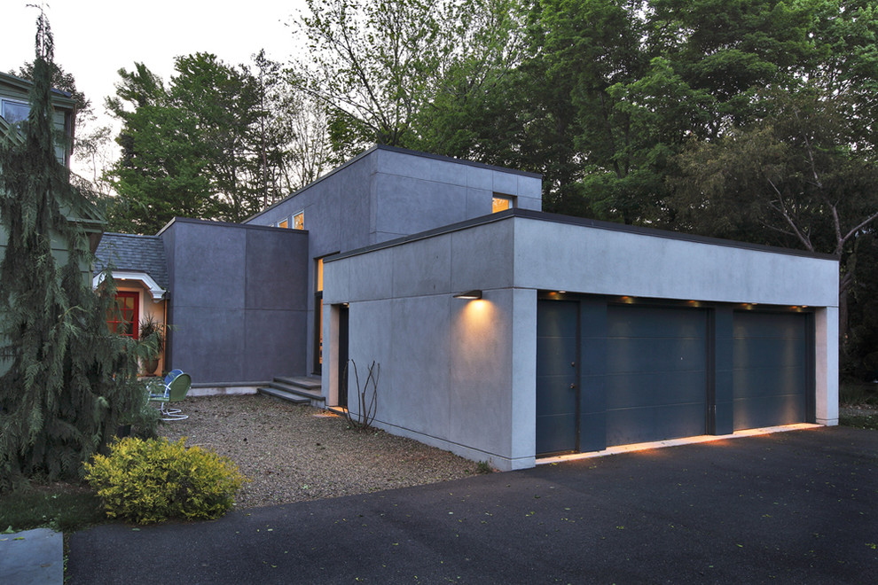 На фото: пристроенный гараж в стиле модернизм для двух машин