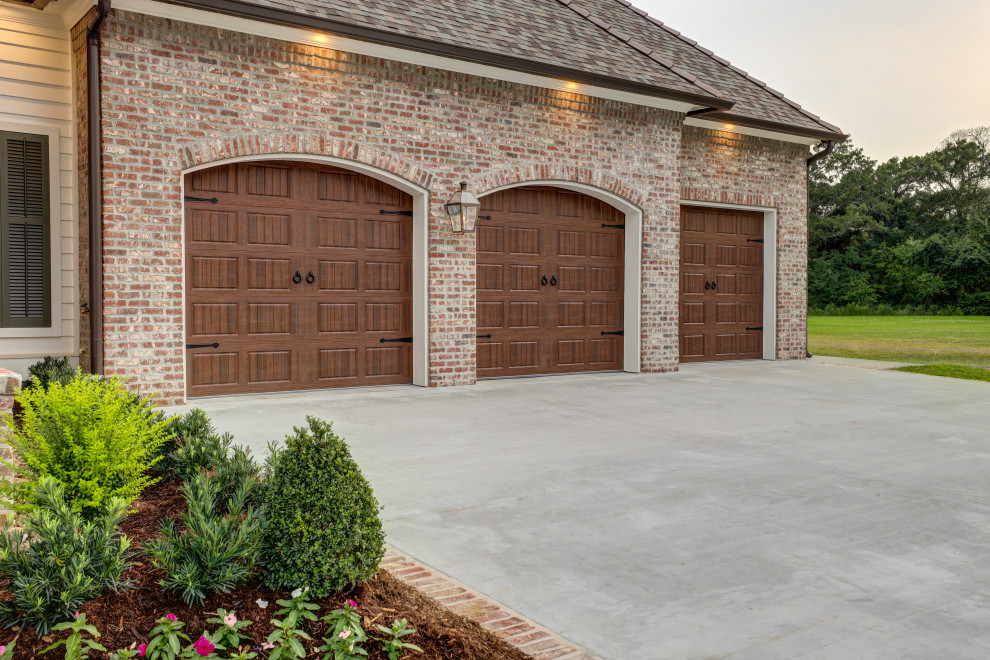 Example of a french country garage design in New Orleans