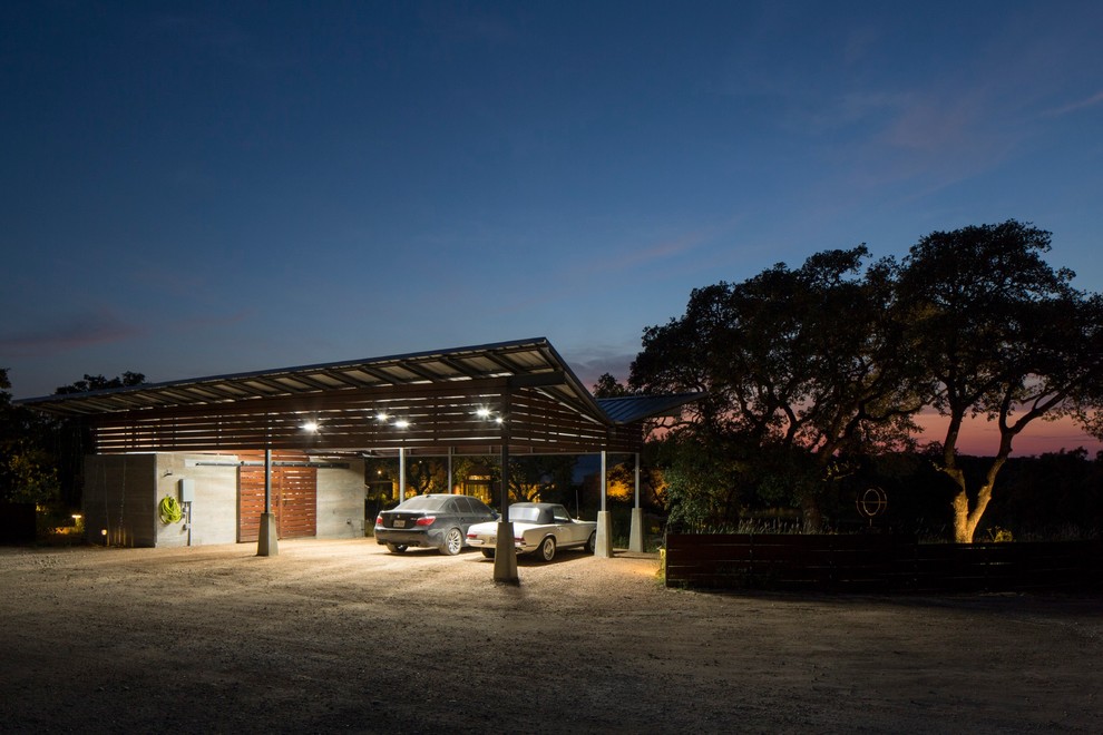 Photo of an expansive midcentury detached carport in Austin with three or more cars.