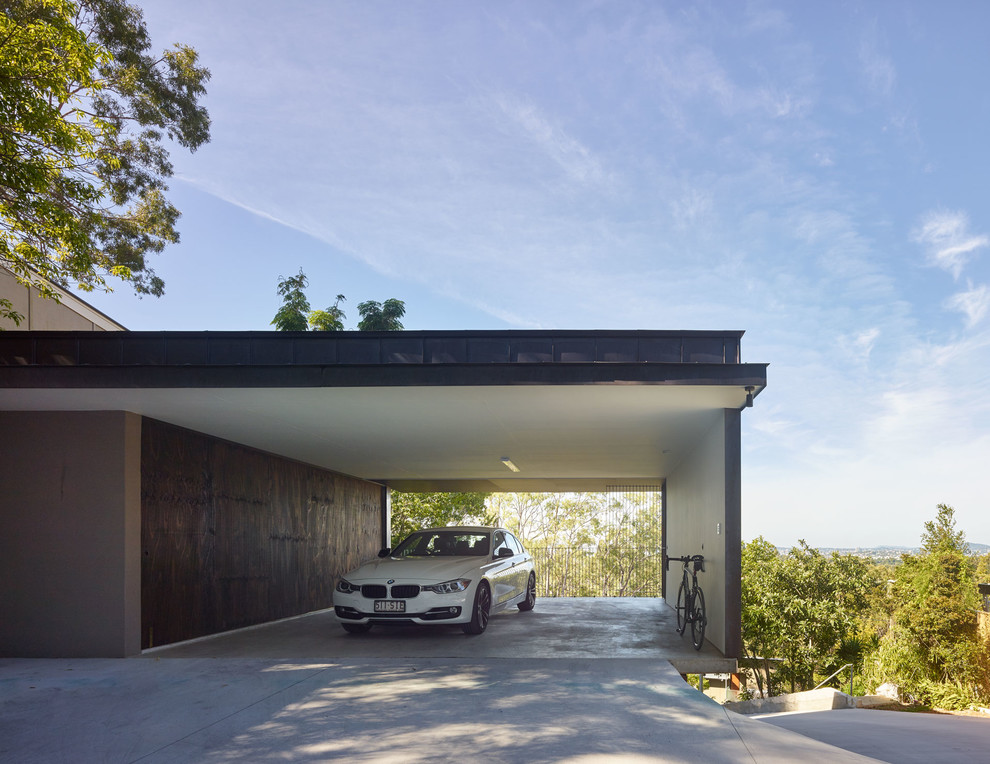 This is an example of a large contemporary detached carport in Brisbane with three or more cars.