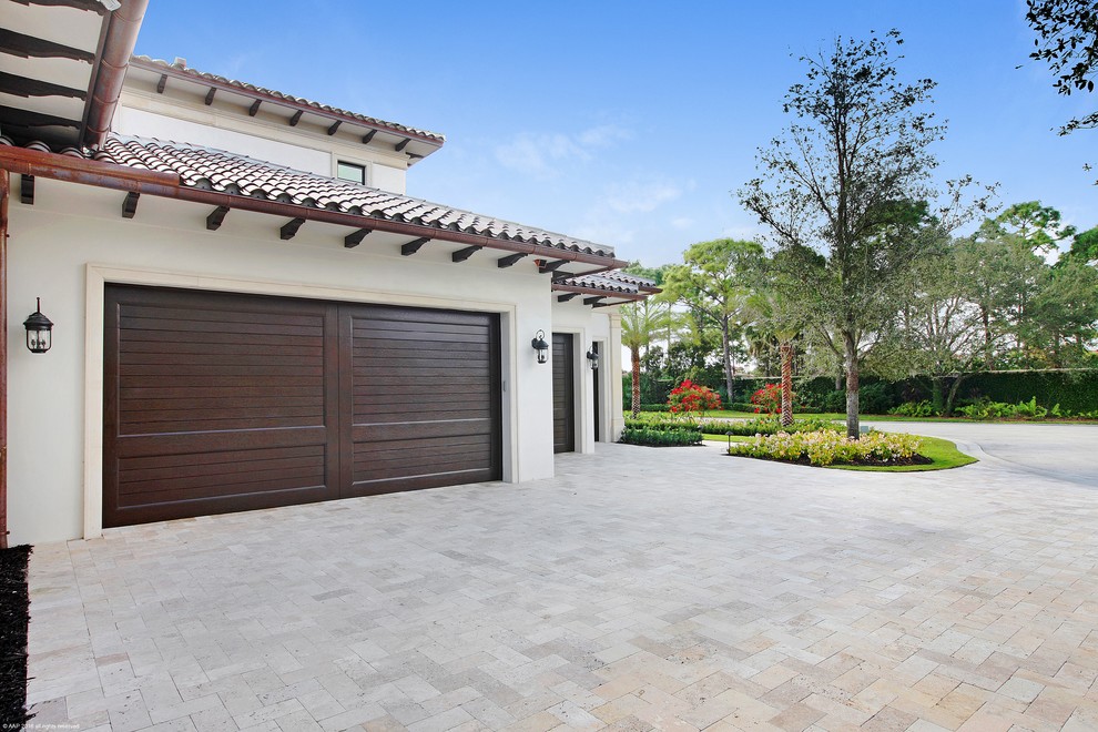 This is an example of an expansive mediterranean attached garage in Miami with four or more cars.
