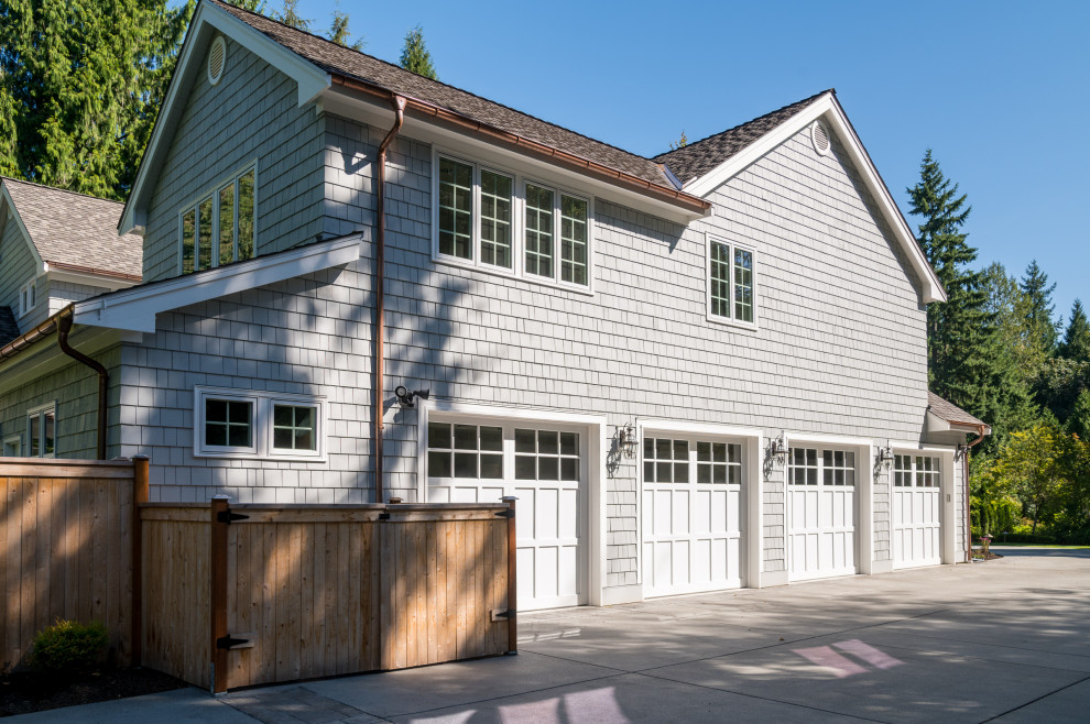 Example of a large transitional attached four-car garage workshop design in Seattle