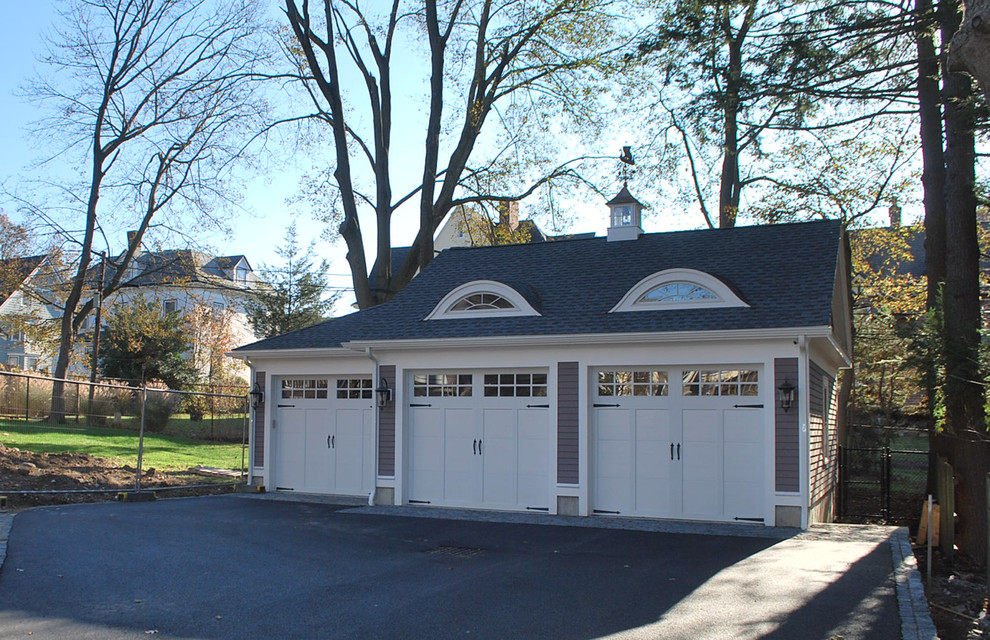 Design ideas for a large victorian detached garage in Boston with three or more cars.