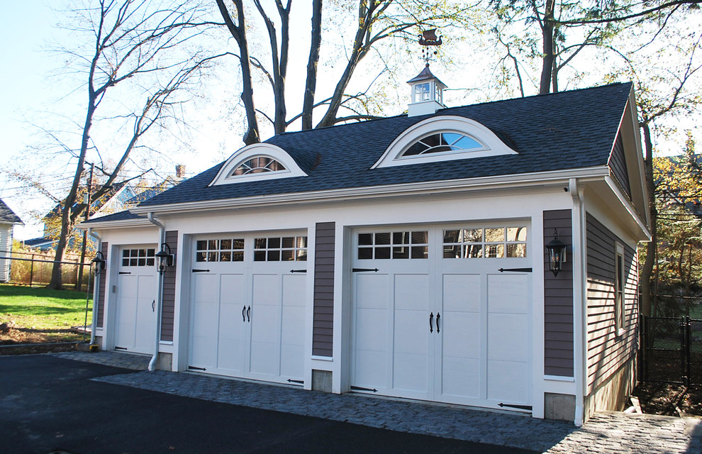Design ideas for a large victorian detached garage in Boston with three or more cars.