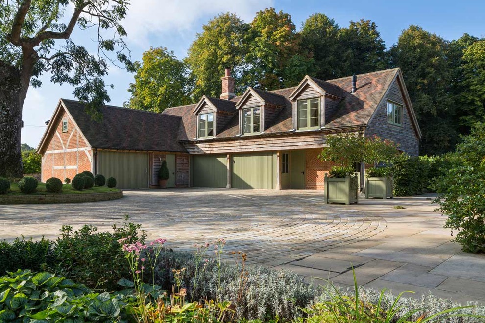 Example of a large classic four-car garage design in Berkshire