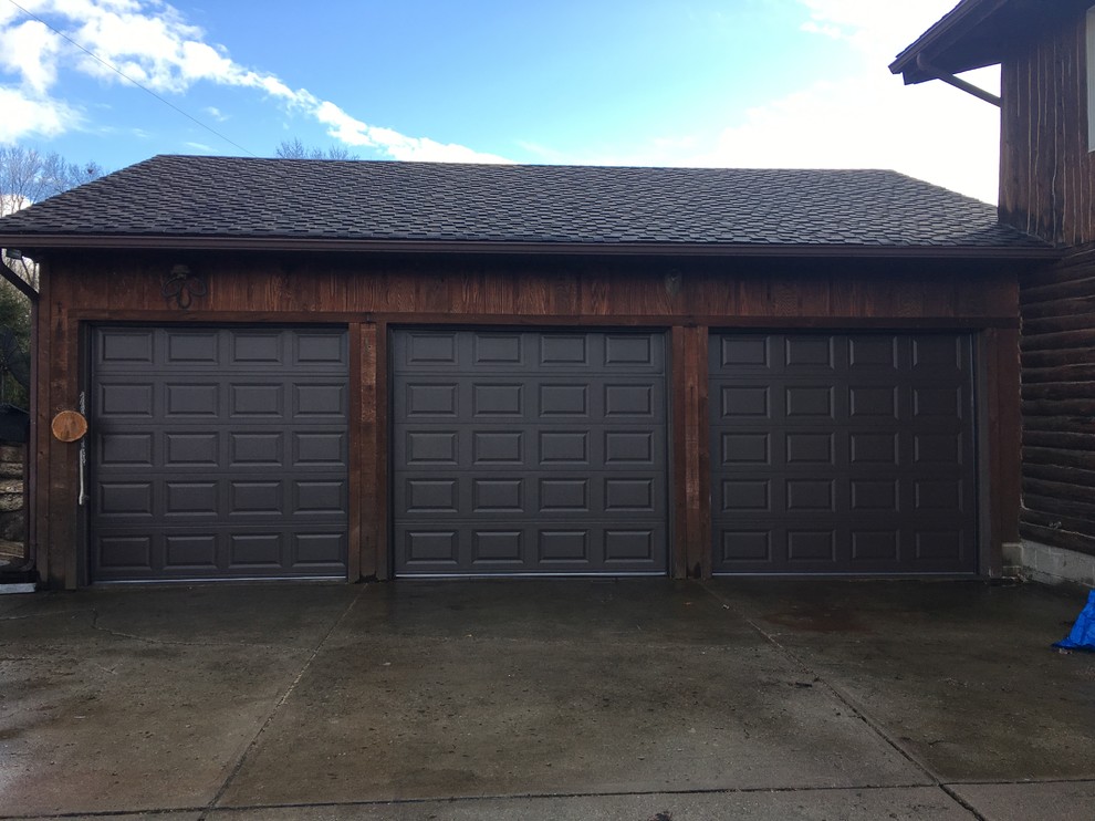 This is an example of a large classic attached garage in Cleveland with three or more cars.
