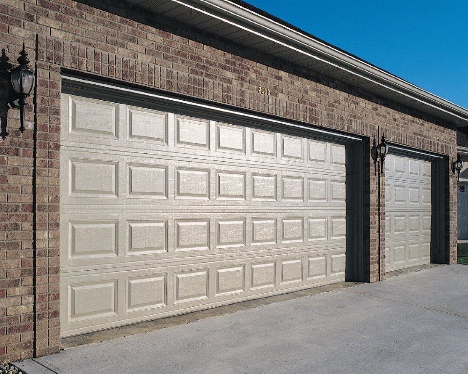 Example of a large classic attached three-car garage design in Cleveland