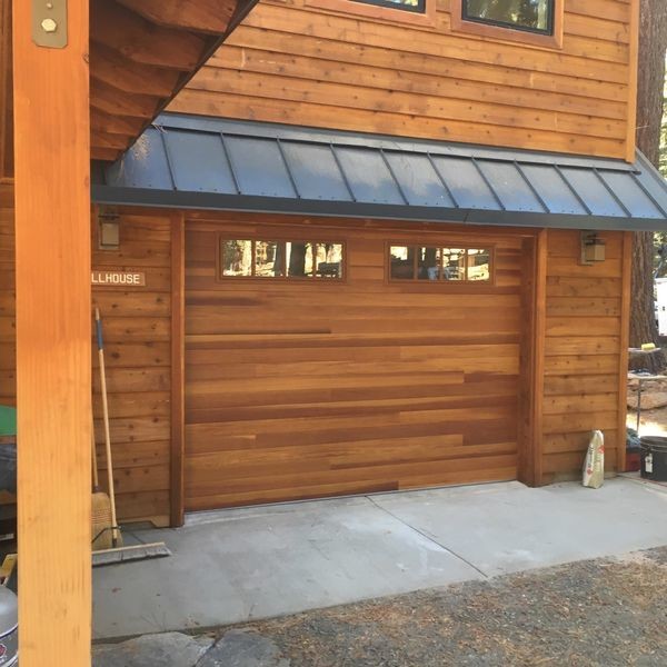 Garage - large rustic attached one-car garage idea in Cleveland