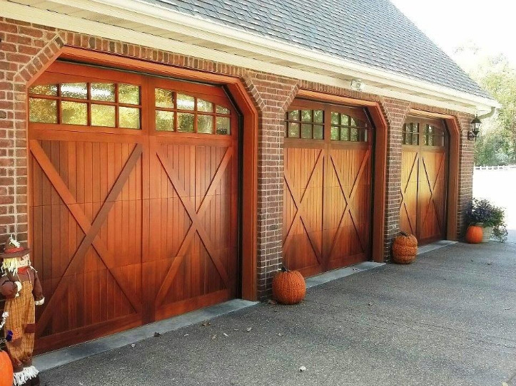 Example of a large classic attached three-car garage design in Cleveland