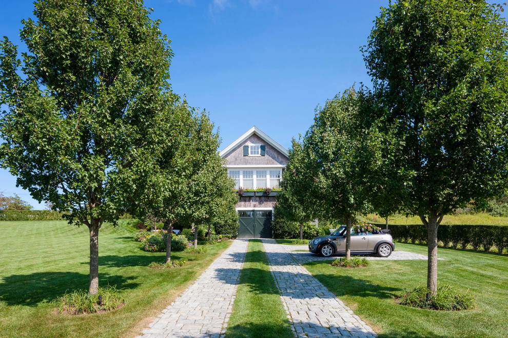 Inspiration for an expansive nautical detached garage in Boston with three or more cars.