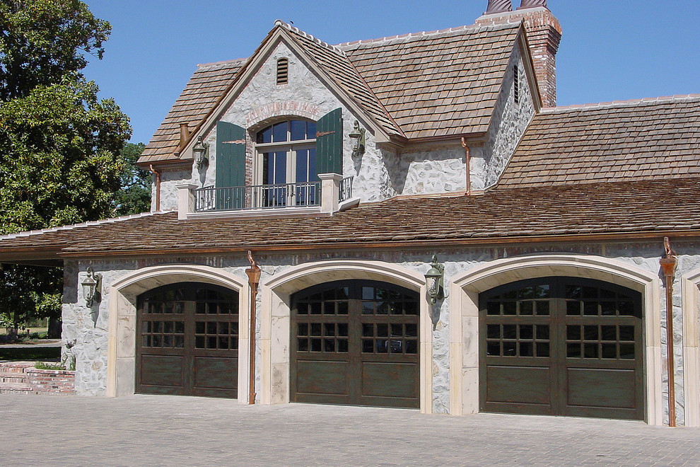 Example of a large classic attached three-car garage design in Los Angeles
