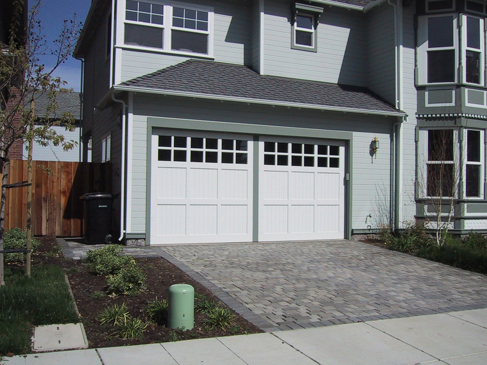 This is an example of a medium sized traditional attached garage in Los Angeles with three or more cars.