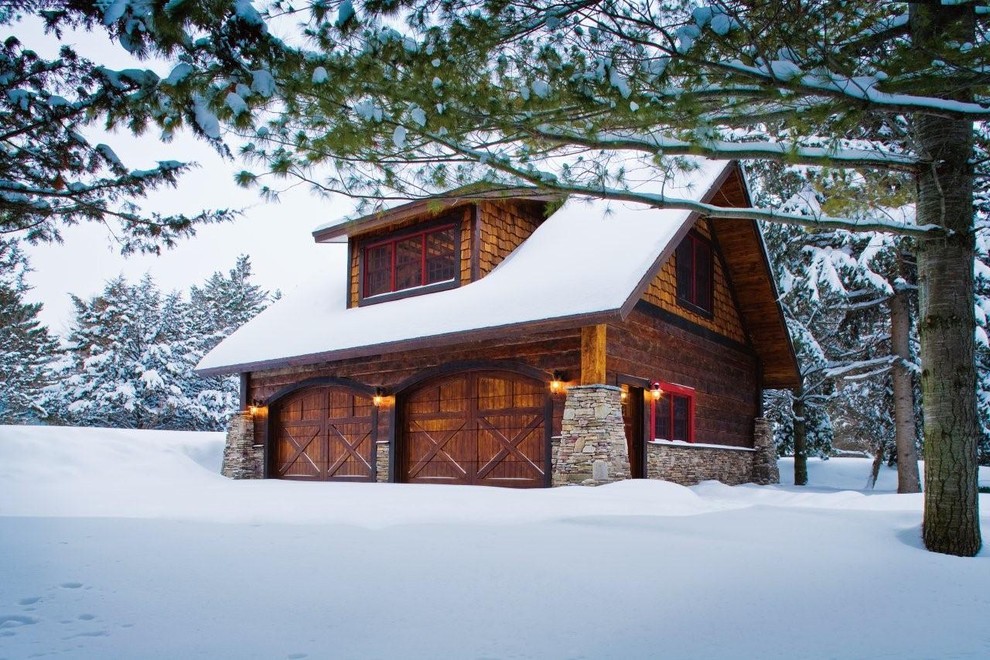 Large mountain style detached two-car garage photo in Minneapolis