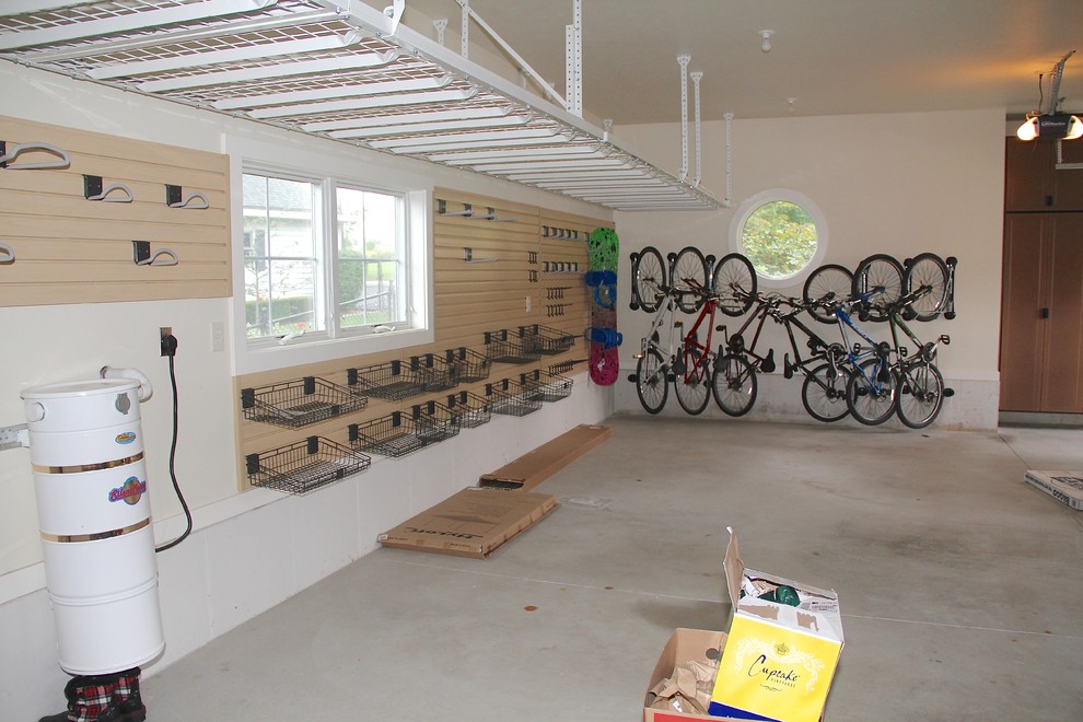 Inspiration for a large attached three-car garage remodel in Other