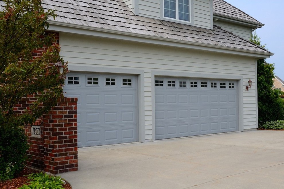 Garage - mid-sized traditional attached three-car garage idea in New York