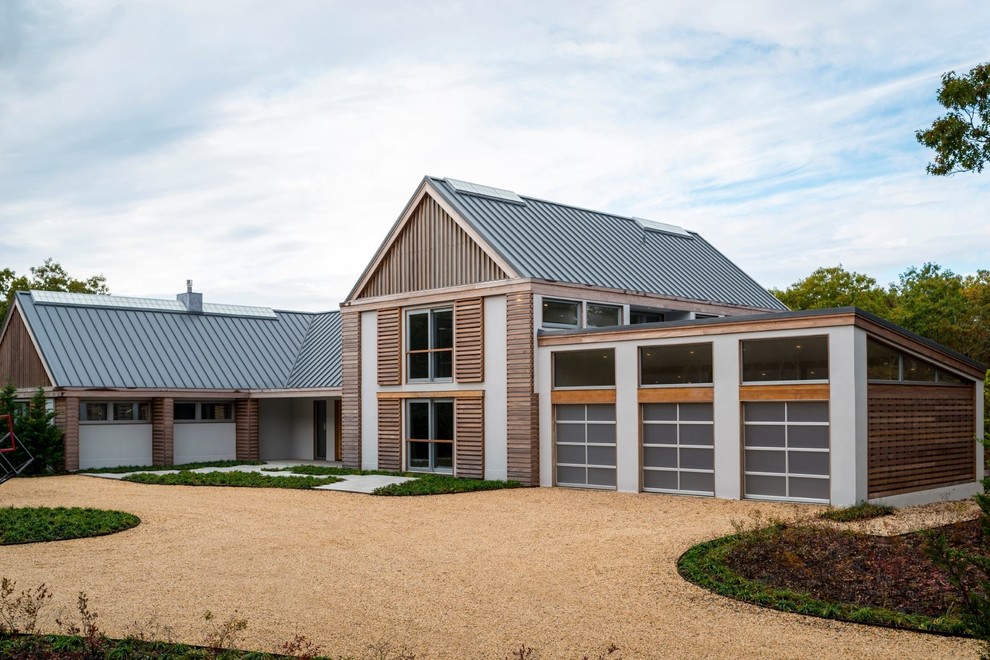 Inspiration for a large contemporary attached three-car garage remodel in Charlotte
