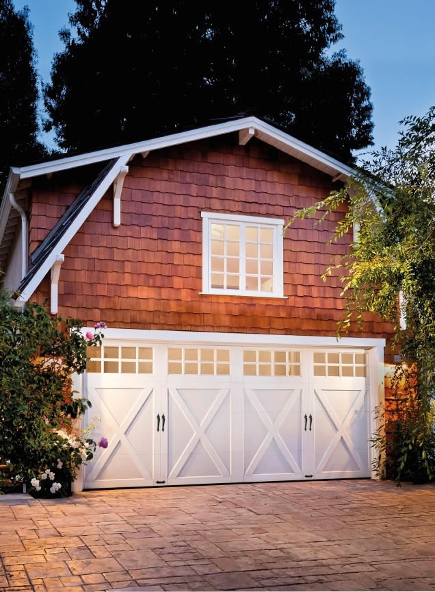 Inspiration for a mid-sized cottage attached two-car garage remodel in Other