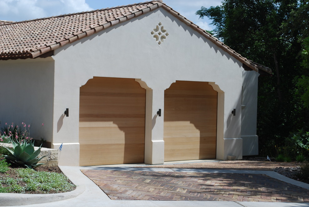 Large tuscan attached two-car garage photo in Austin