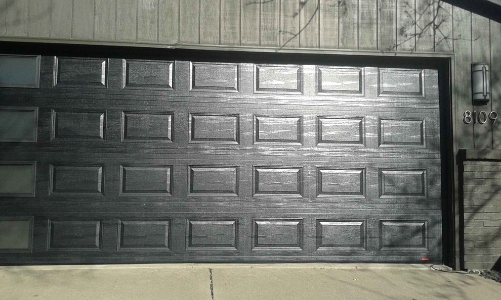 Garage - mid-sized contemporary attached two-car garage idea in Cedar Rapids