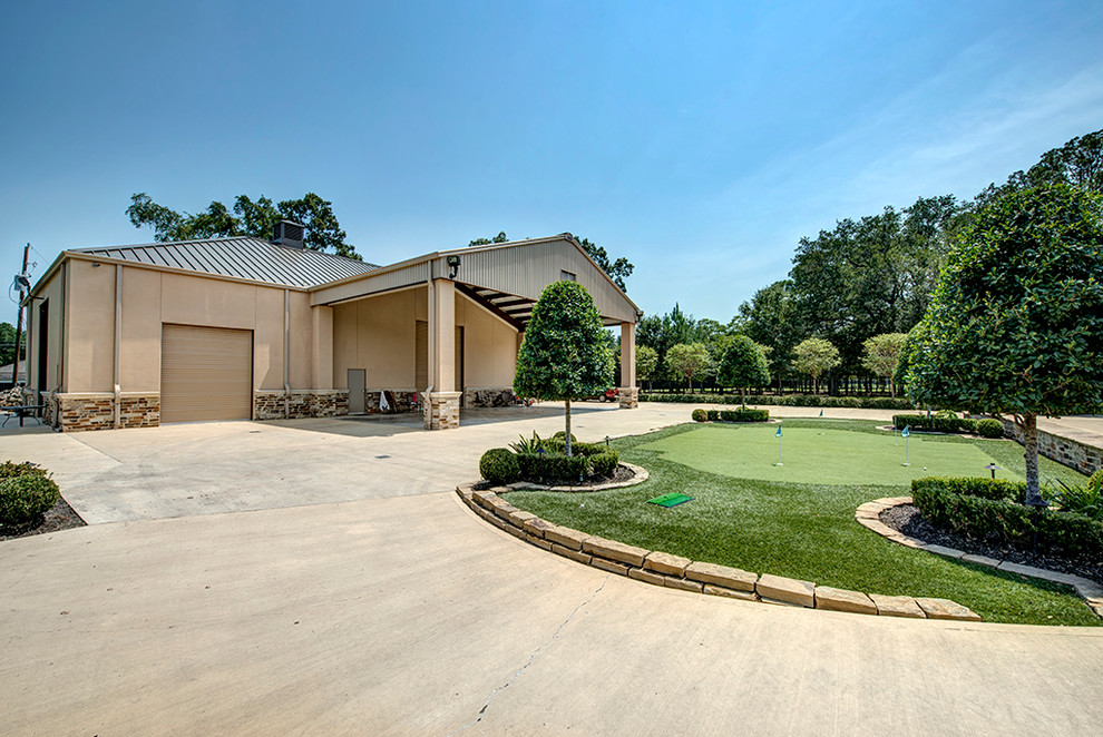 Example of a huge classic detached four-car garage design in Houston