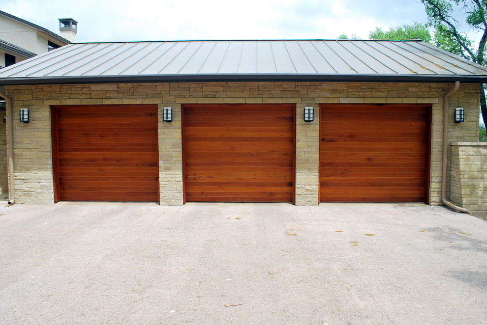 This is an example of a large modern attached garage in Austin with three or more cars.