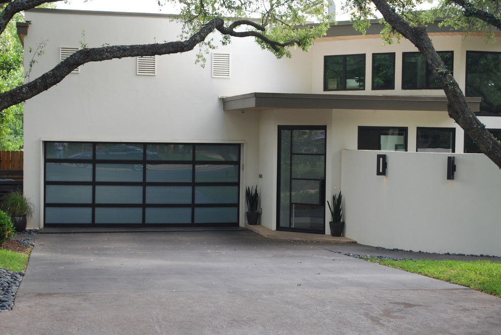 Inspiration for a large contemporary attached two-car garage remodel in Austin