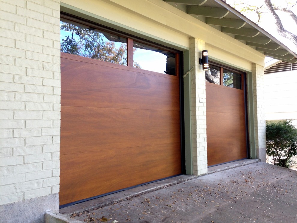 Medium sized contemporary attached double garage in Austin.