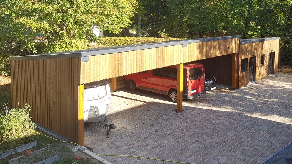 Photo of a medium sized contemporary detached carport in Paris with four or more cars.