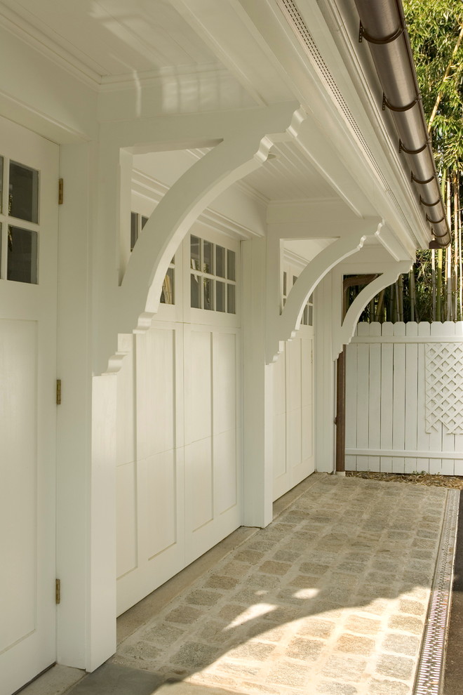 Example of a large classic three-car garage design in Other