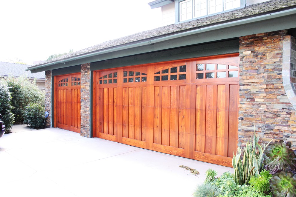 Réalisation d'un garage pour une voiture attenant craftsman de taille moyenne avec une porte cochère.