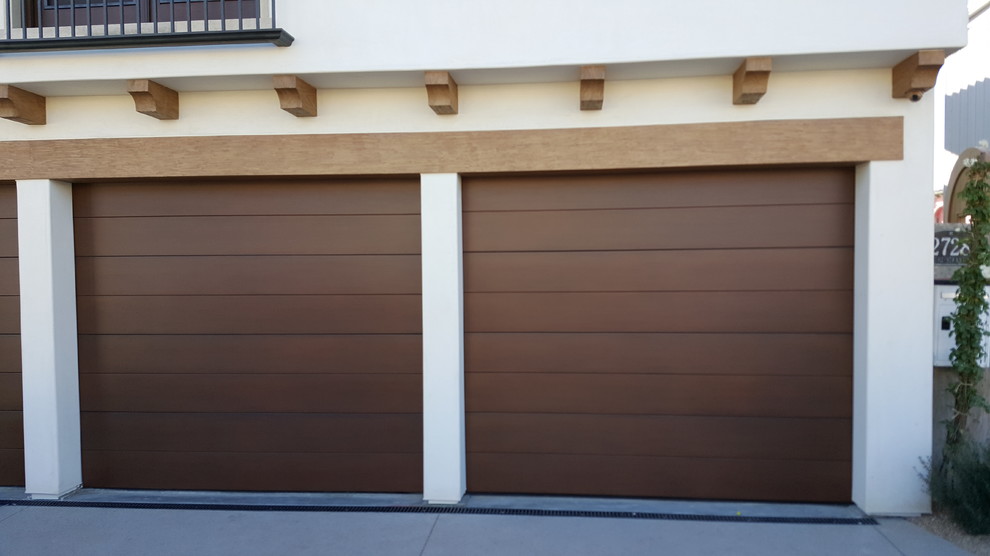 Example of a mid-sized minimalist attached two-car garage design in Los Angeles