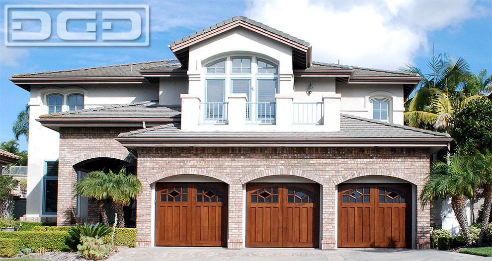 Example of a huge classic attached three-car garage design in Orange County